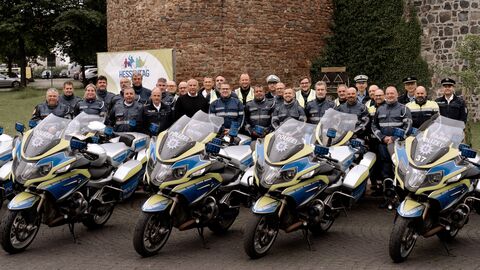 Innenminister Roman Poseck mit Kradstaffel auf dem Hessentag. Im Vordergrund stehen Motorräder der hessischen Polizei.